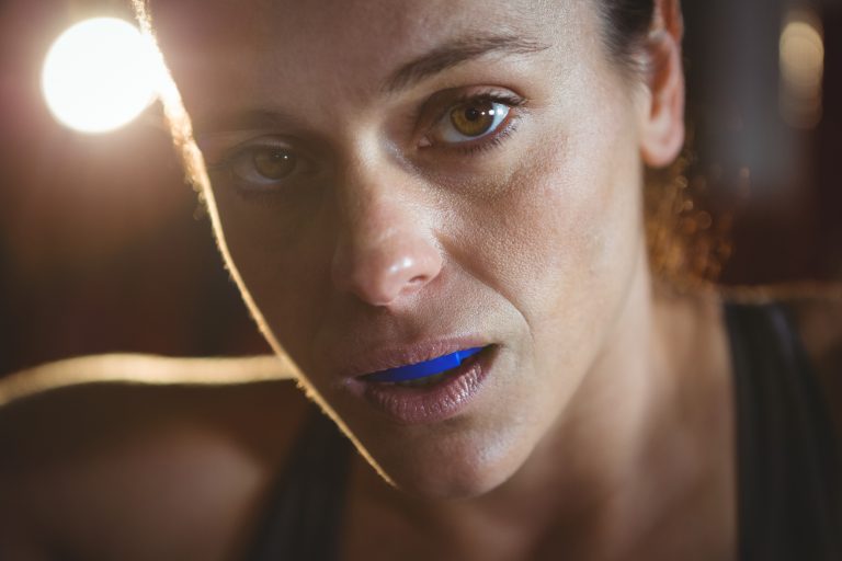 Close-up of confident female boxer in fitness studio