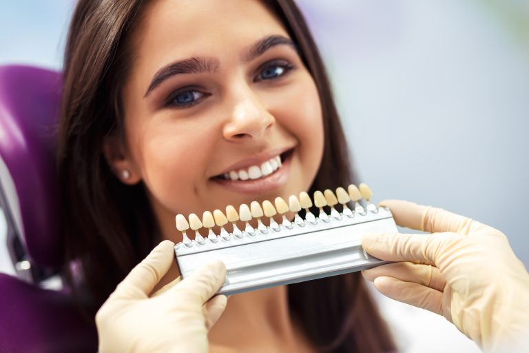 Overview of dental caries prevention. Woman at the dentist's chair during a dental procedure.. Healthy Smile.