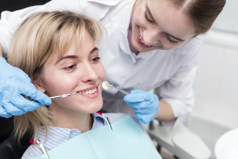 portrait-dentist-performing-treatment-patient