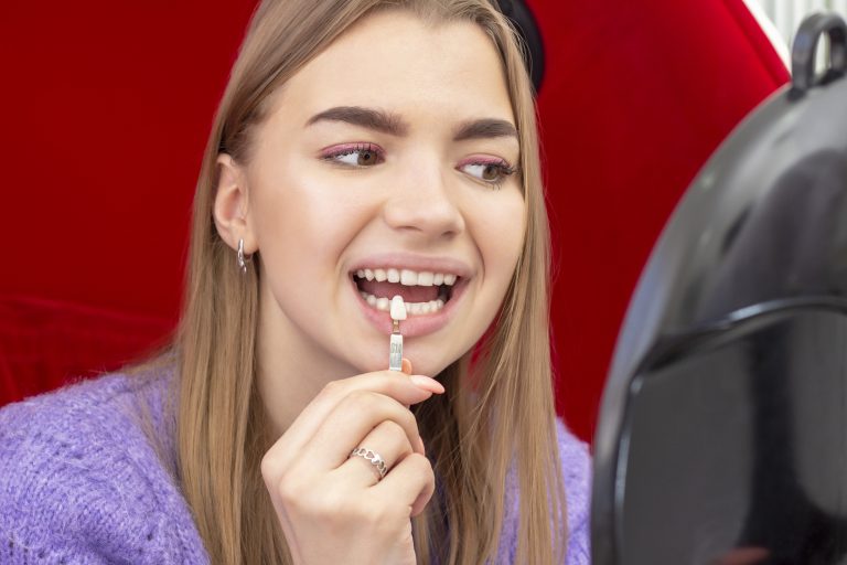 teeth whitening procedure girl pick up the shade of teeth