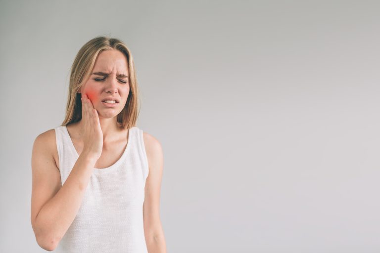 Teeth Problem. Woman Feeling Tooth Pain. Closeup Of Beautiful Sad Girl Suffering From Strong Tooth Pain. Attractive Female Feeling Painful Toothache. Dental Health And Care Concept